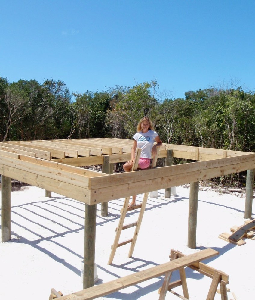 Julie building her remote island home by hand on a wooden platform