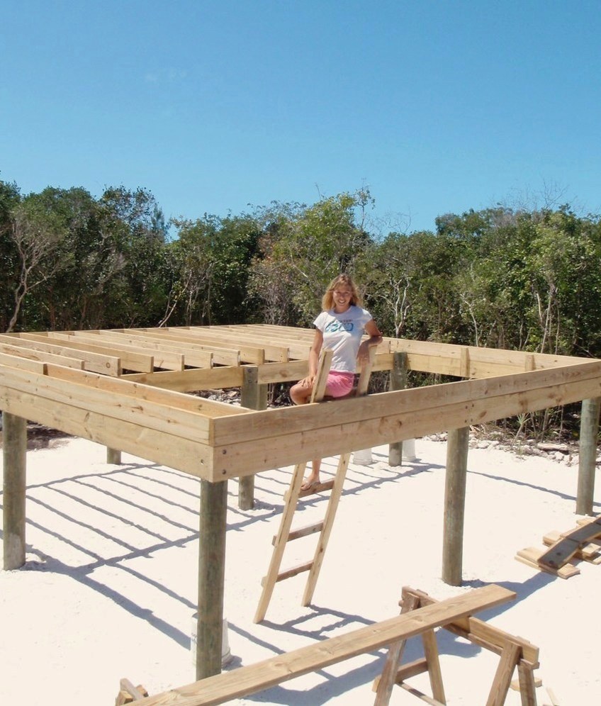 Julie building her remote island home by hand on a wooden platform